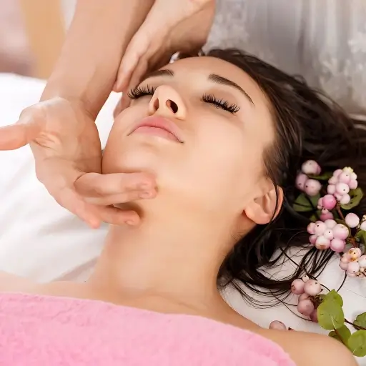 A close-up of a woman receiving a facial treatment at Bristol Beauty Line. The image shows gentle hand movements and a relaxing spa atmosphere.