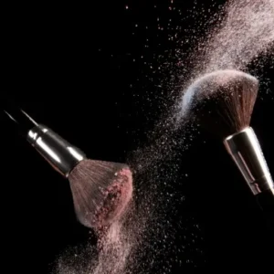 Makeup brushes with powder, showcasing professional beauty tools for makeup application.